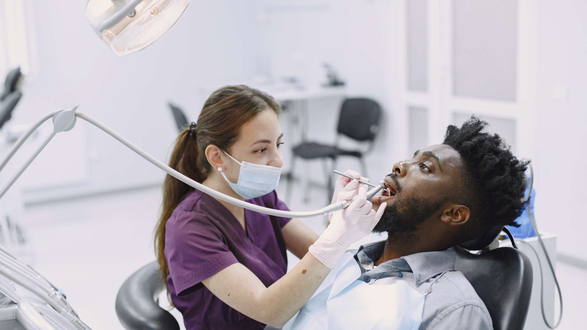 young-african-american-man-guy-visiting-dentist-s-office-prevention-oral-cavity-man-famale-doctor-while-checkup-teeth