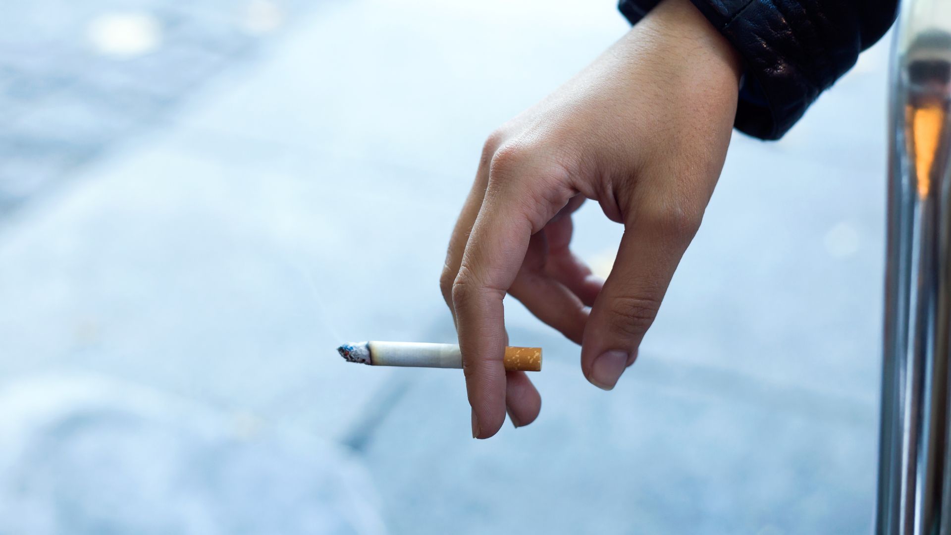 womans-hand-with-cigarette-street