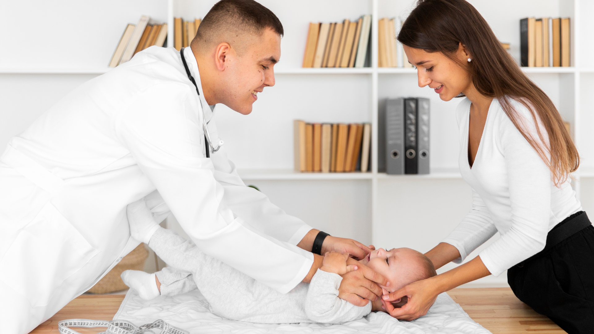 lateral view smiling doctor looking baby patient