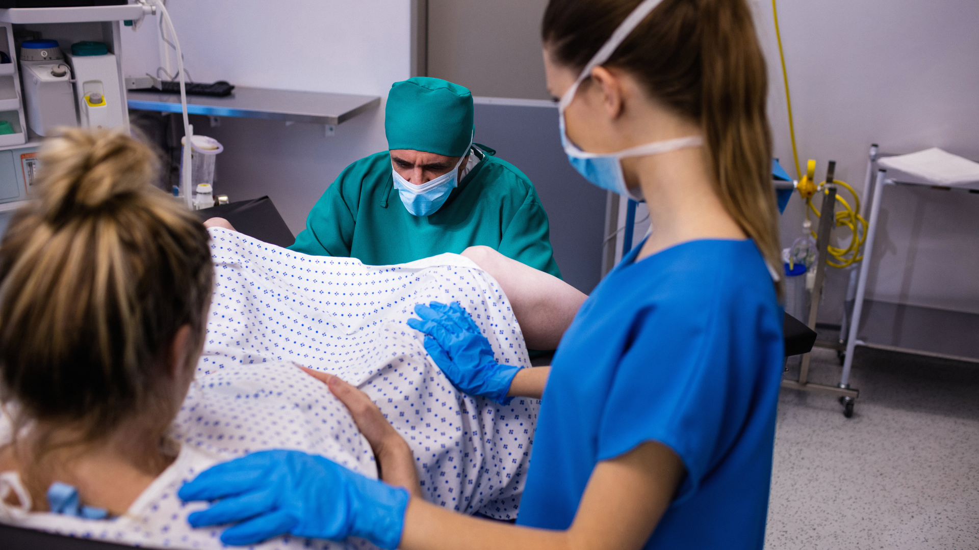 medical team examining pregnant woman during delivery