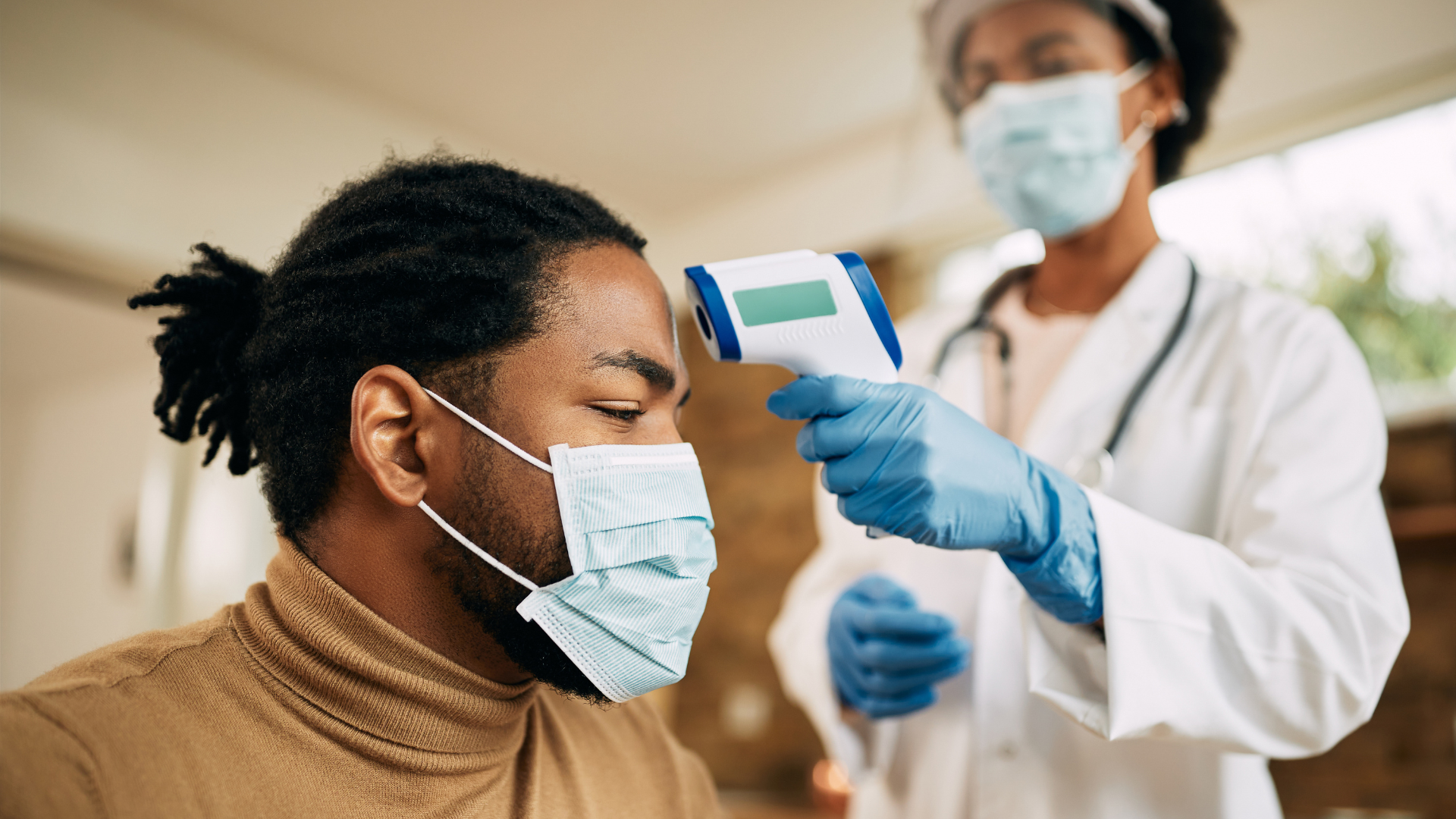 doctor checking black man for covid 19