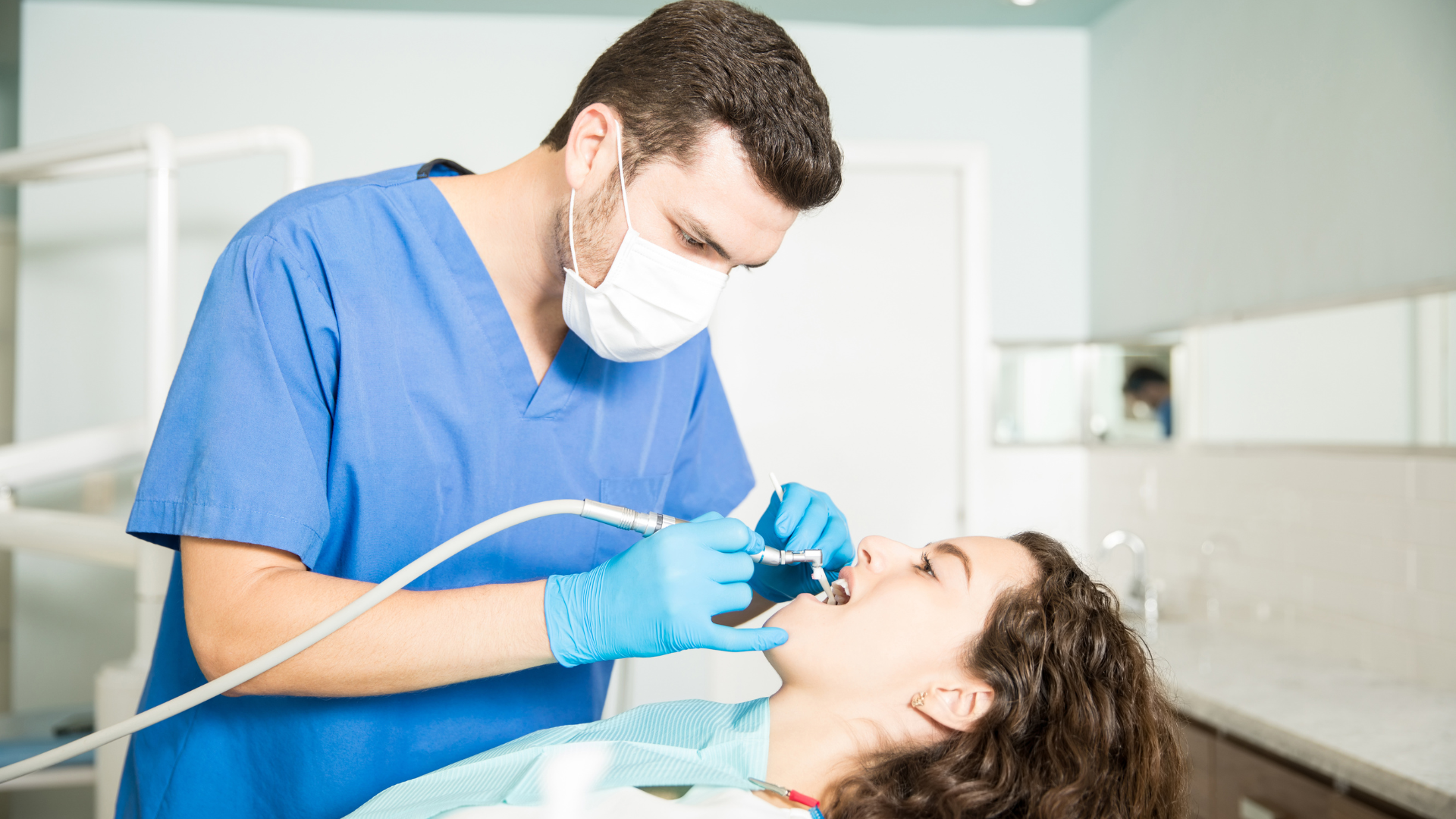 young-woman-receiving-dental-treatment-from-male-dentist-clinic